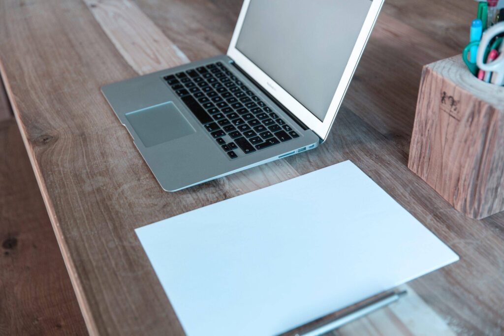 laptop on top of wooden desk gecko hospitality